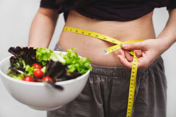 Indian woman wondering why she is gaining weight despite eating healthy meals.